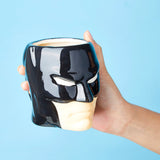 Hand Holding Batman Mug on Blue Background