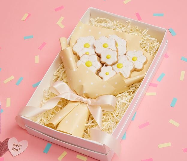 Bouquet Of Flower Shaped Cookies pink and white , In Gift Box On A Pink Background