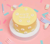 Mini Filled Sponge Cake With Daisies In Yellow On A Pink Background